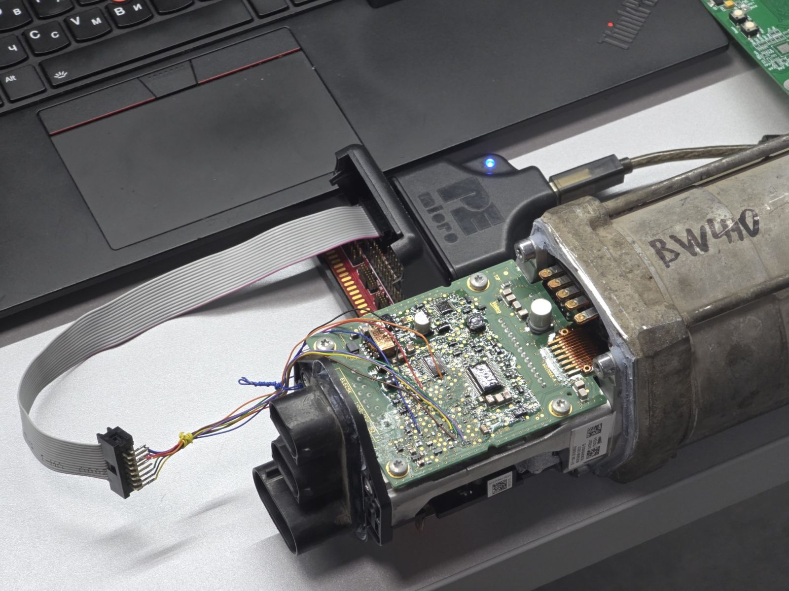 A P&E probe on the rack's debug header during reverse engineering